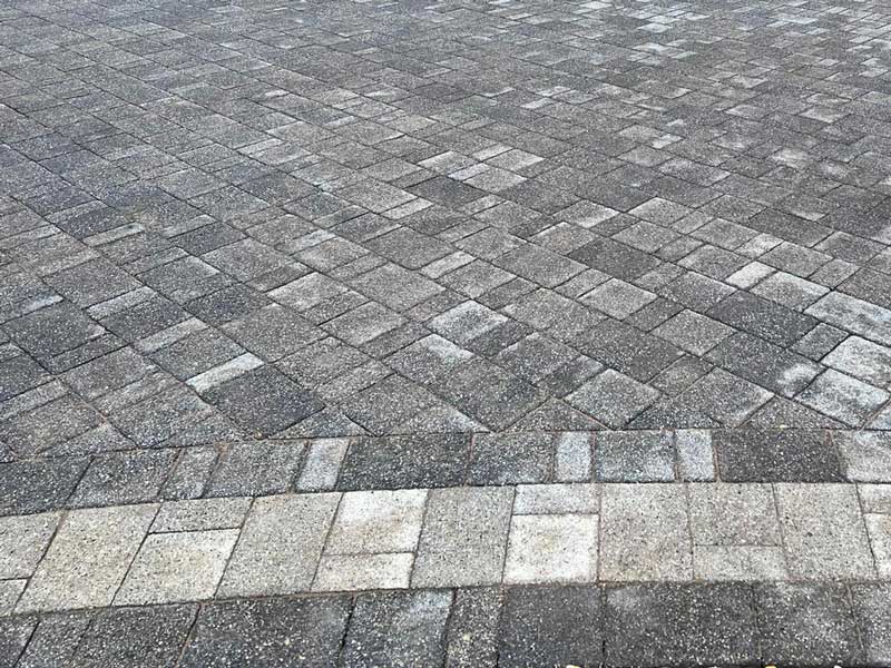 slightly curved edge to concrete paver driveway with neat contrasting border