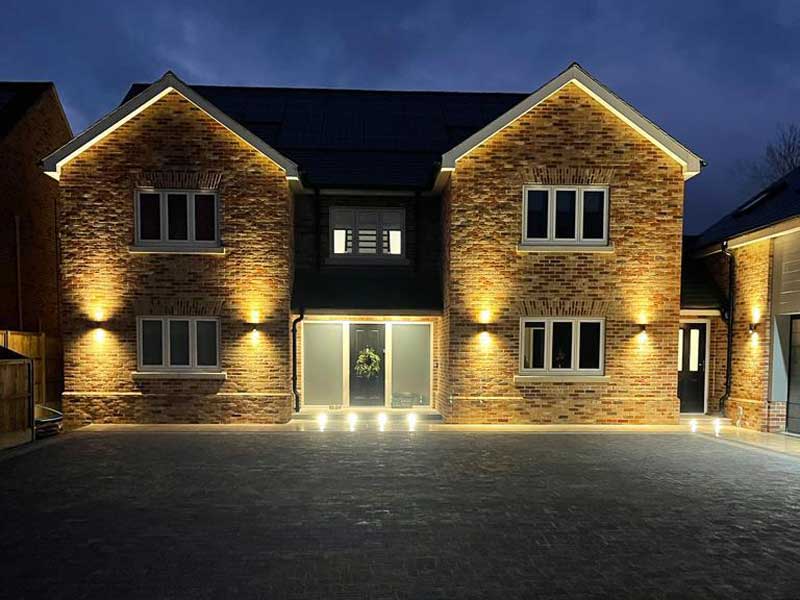 large newbuild property with generous sized driveway and attractive outdoor lighting