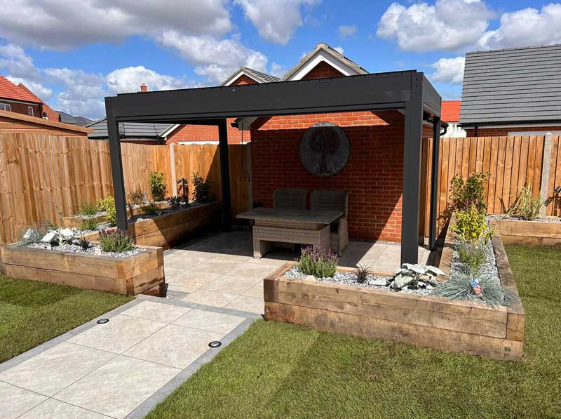 newbuild back garden with patio sheltered by a contemporary pergola