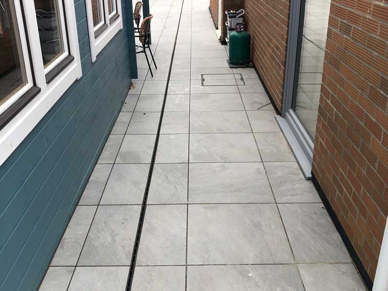 paved walkway with a discreet but efficient drainage channel