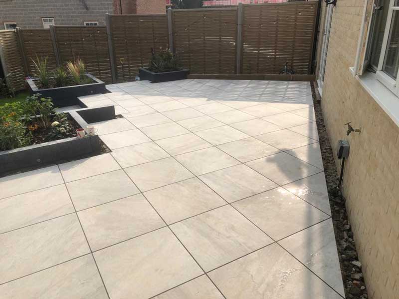 stylish porcelain paving patio with built in raised beds