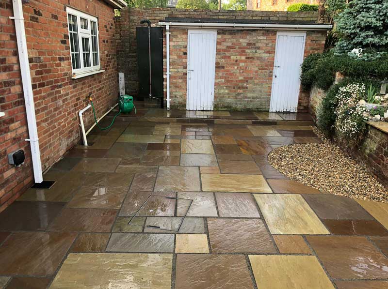 Natural sandstone patio in a traditional style Norfolk garden