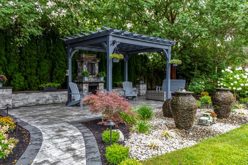 timber pergola beneath the trees creating a wonderfully shaded spot in a garden